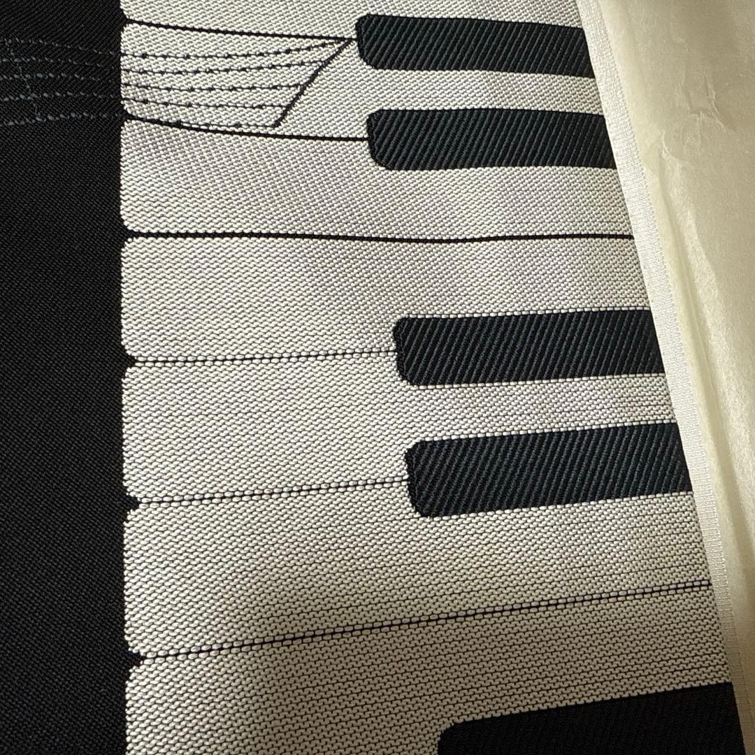 仕立上がり九寸六通名古屋帯　黒地　ピアノ　鍵盤　カラフル　音符　未使用品